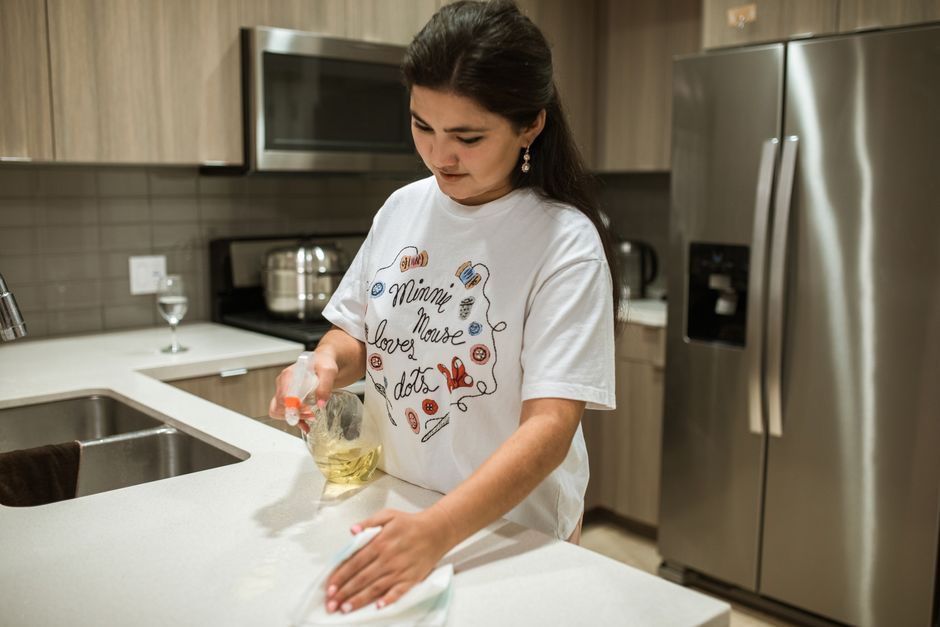 Wiping down kitchen counters during recurring cleaning